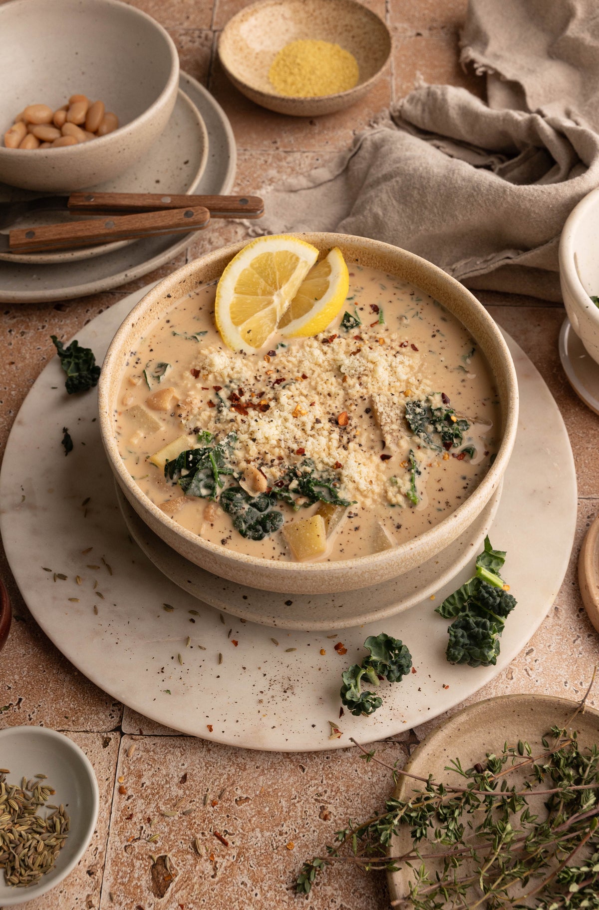 Creamy Tuscan soup with white beans, potatoes and greens, topped with lemon and a crumb topping.